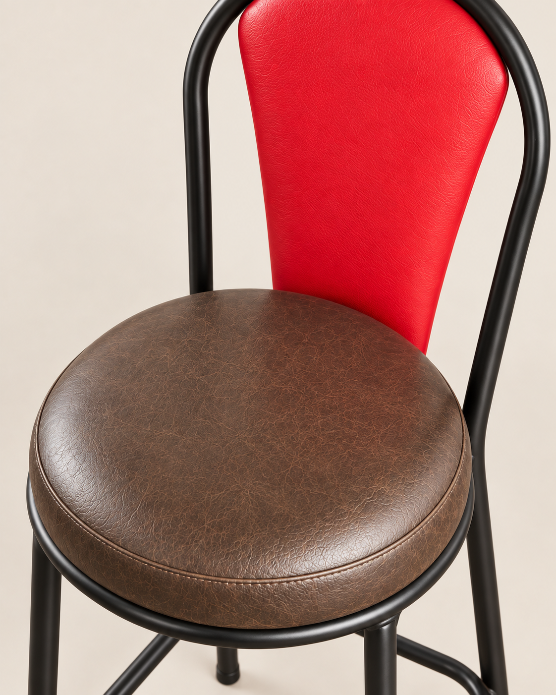 Handmade Kenyan chair with a round brown padded seat, red upholstered back and slim black bent-tube frame