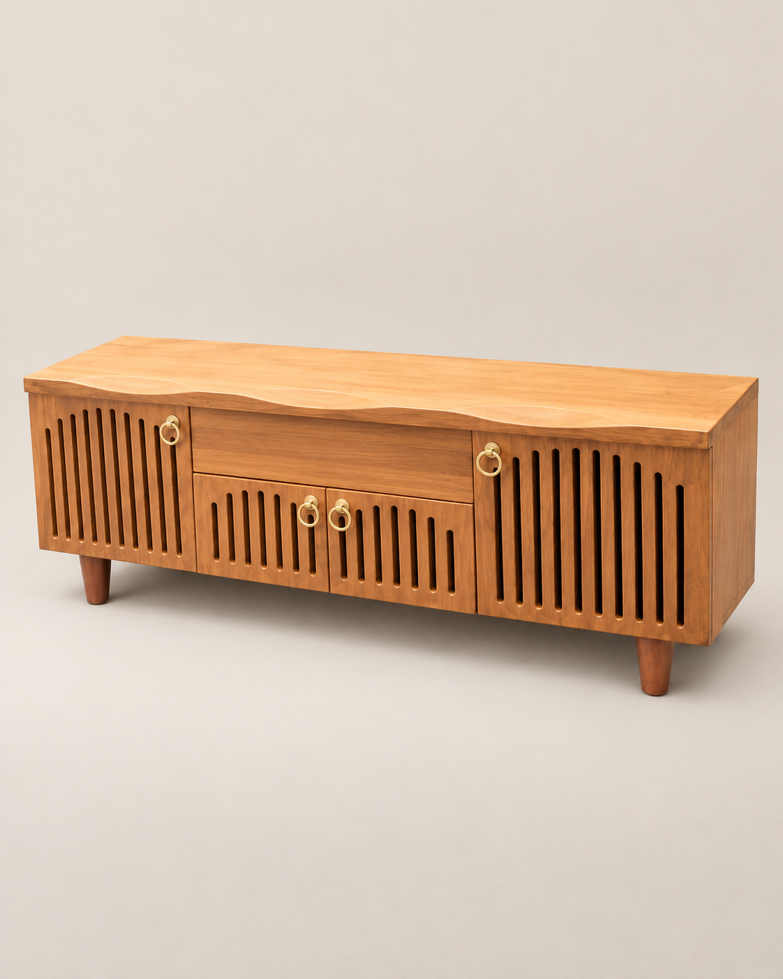 Low mahogany-toned TV stand handcrafted in Kenya, with slatted doors, brass-coloured ring pulls, a wave-cut top and tapered legs